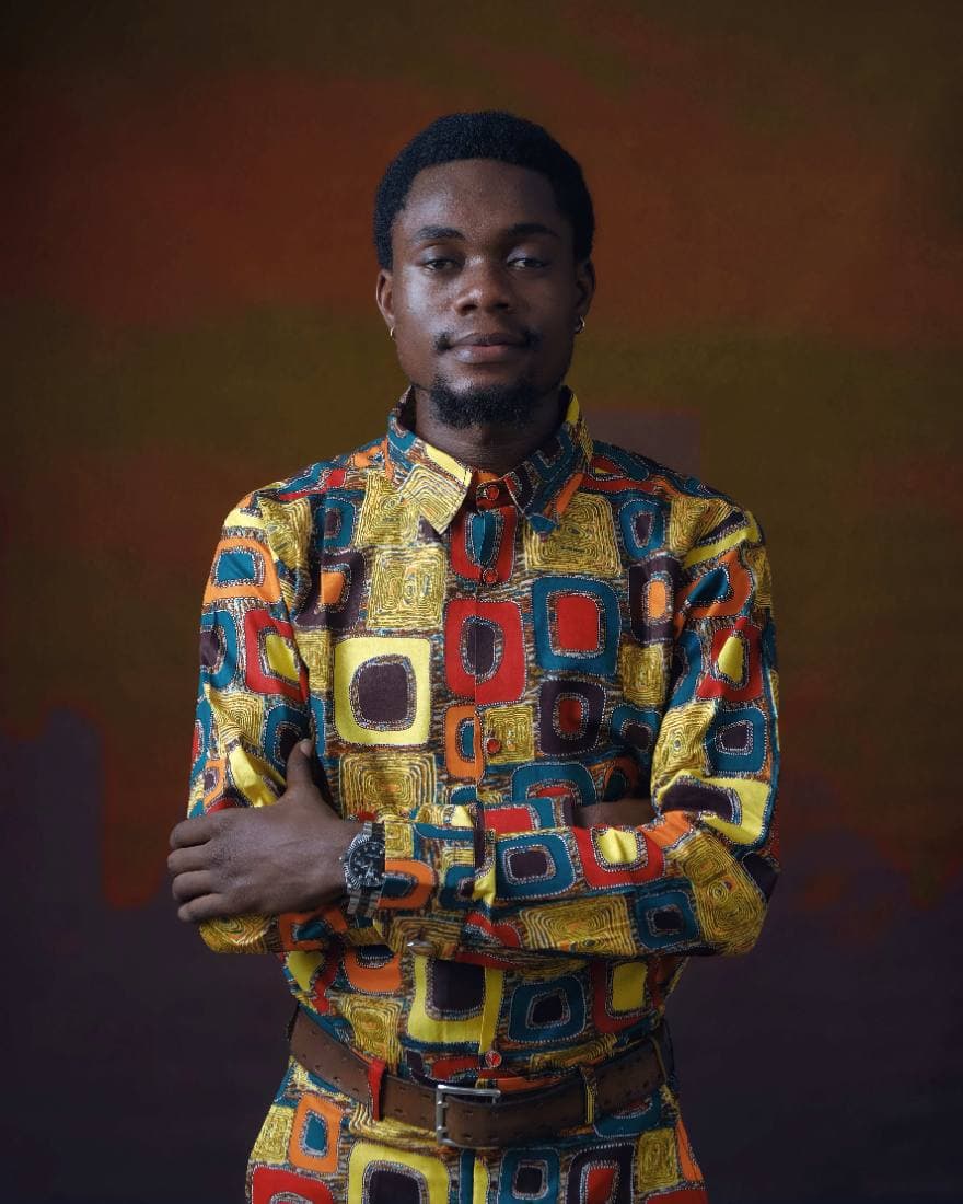 A man in a hand-finished A&C two-piece, photographed against a warm studio backdrop